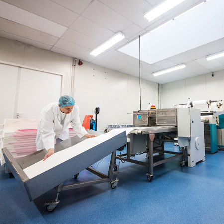 Employee stacking sheets of wafer paper