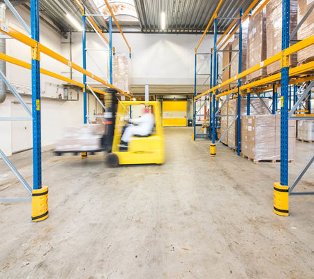 Factory worker driving forklift truck