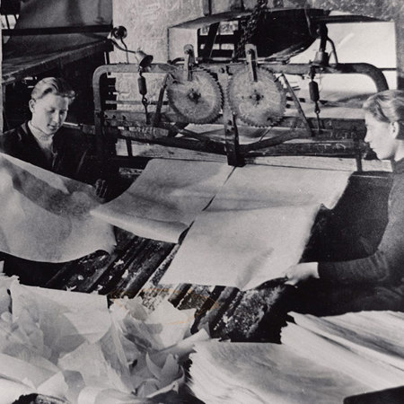 Factory workers processing wafer paper in to sheets