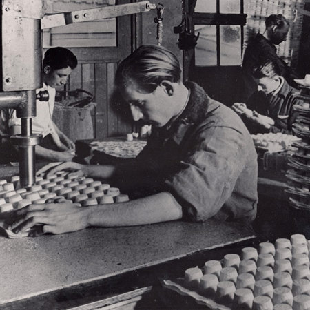 Factory worker cutting wafer paper 